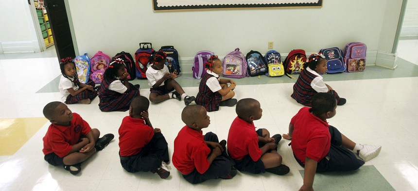 Kindergarten students sit in a hallway at the charter school Benjamin Franklin Elementary Mathematics and Science in New Orleans, Louisiana. 
