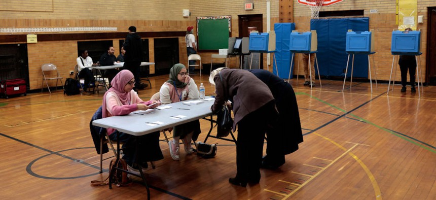 Voters check in at a polling location during the Michigan presidential primary in Dearborn, Michigan, on February 27, 2024. 