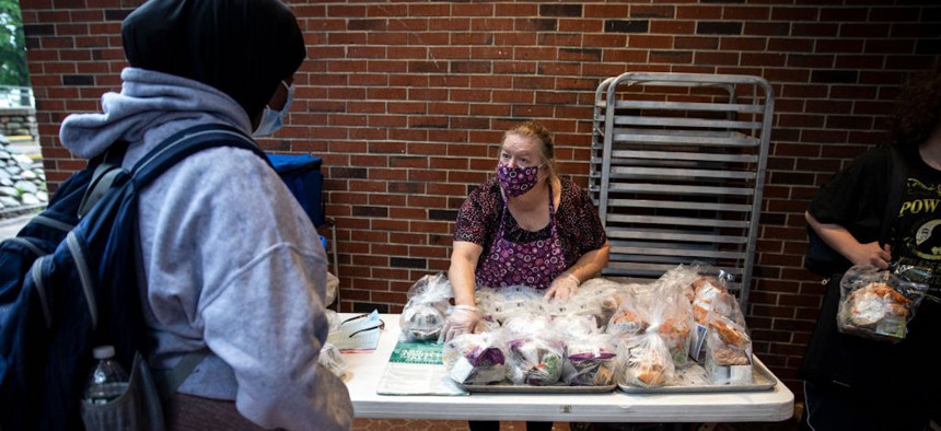 Deborah Jendrasko gives out free lunches for to students at Deering High School on July 9, 2021. The meals are available to any children from the community 18 or under. Maine is participating in the summer EBT program this year.