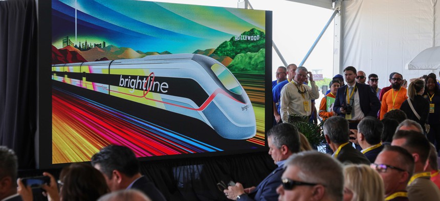 A monitor displays a presentation as attendees wait for an April groundbreaking ceremony at a Brightline station in Las Vegas, Nevada. 