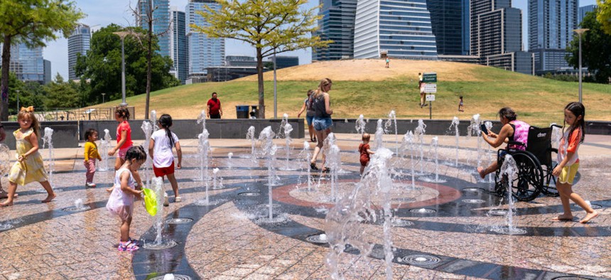 Residents cool off in the Liz Carpenter Splash Pad at Butler Park on July 16, 2023, in Austin, Texas, during a heat wave.