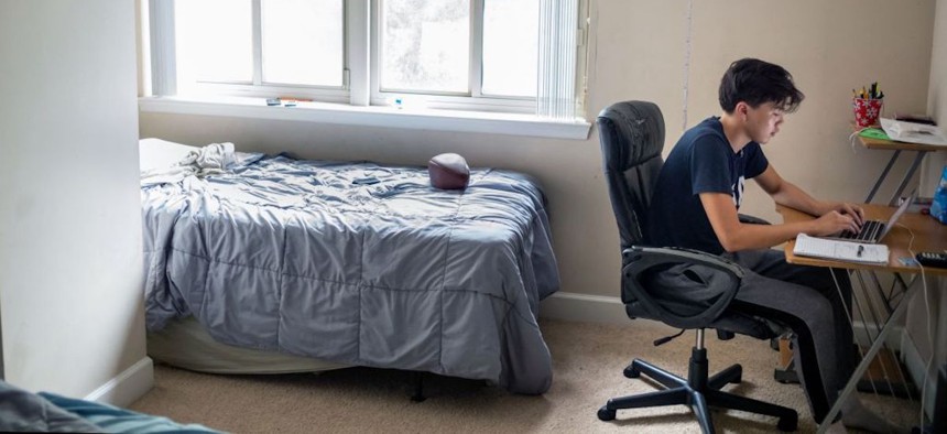 An 11th grade student at Wakefield High School, studies from his home in Arlington, Virginia.