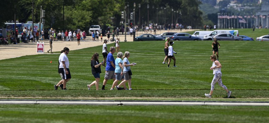 People enjoy the sunny day around the National Mall in Washington D.C., on Aug. 14, 2023. 