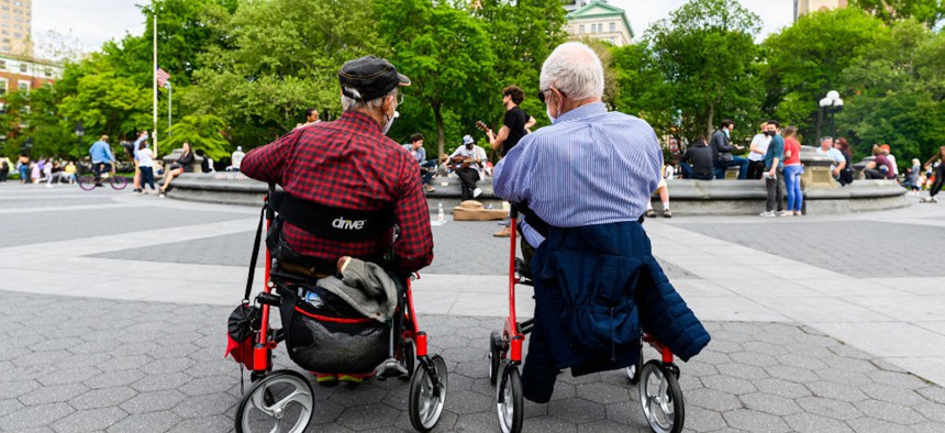 People wear protective face masks in Washington Square Park during the coronavirus pandemic on May 24, 2020, in New York City.