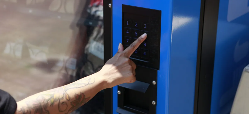 An East New York resident uses a harm reduction vending machine at 2640 Pitkin Avenue on July 17, 2024.