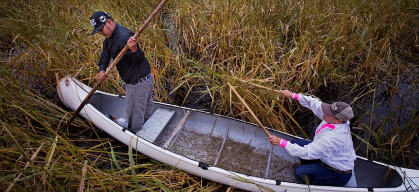 Harvey Goodsky Jr. and his wife Morningstar harvest wild rice during a perfectly calm day on Rice Lake in north central Minnesota. 