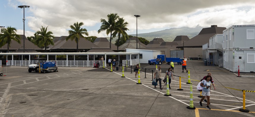 Passengers walk to board an airplance at Ellison Onizuka Kona International Airport at Kehole in Kailua-Kona, Hawaii.