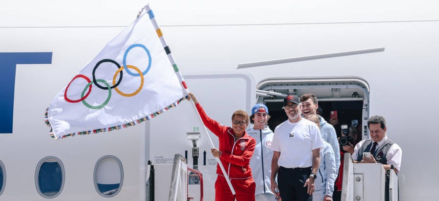 Mayor Karen Bass holds the official Olympic Flag as it returns to Los Angeles for the first time in 40 years.