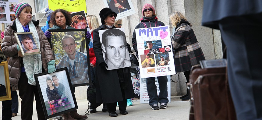 Families who have lost loved ones to the opioid crisis protest in front of Suffolk Superior Court in Boston as lawyers for Purdue Pharma enter the courthouse on Jan. 25, 2019. 