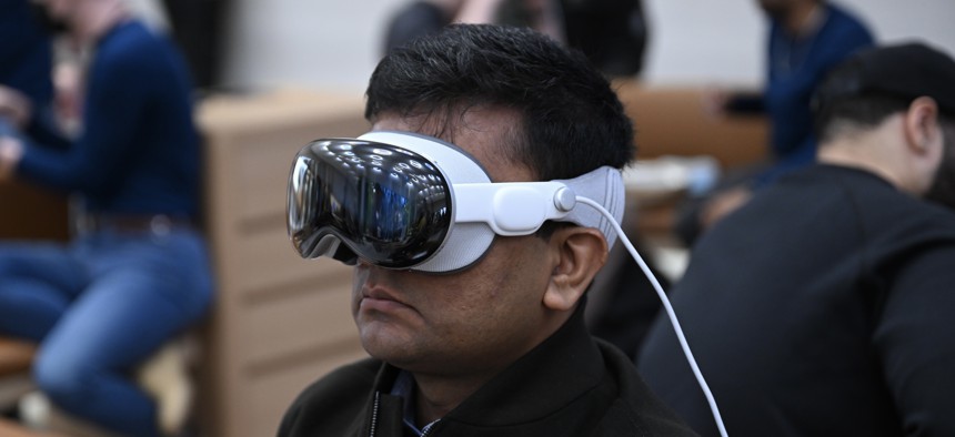 Customers use Apple Vision Pro mixed reality headsets at an Apple store in New York City. 