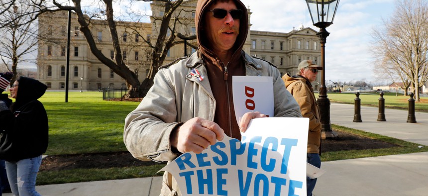 Matthew Shepard, a supporter of then-US President Donald Trump, protests outside the Michigan State Capital in Lansing as Michigan's Board of State Canvassers vote to certify the 2020 election on November 23, 2020.