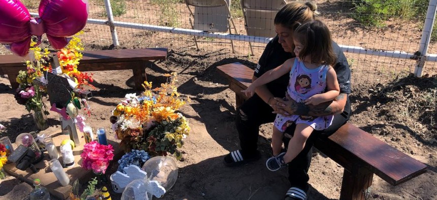 Maria Dominguez at a roadside memorial, or “descanso,” for her daughter Bianca Quintana, who was killed Aug. 14 when she was hit by a car while walking along a busy road near her mother’s house on South Coors Boulevard in Bernalillo County, N.M. With her is Bianca Quintana’s 2-year-old niece Aaliyah Maestas. 