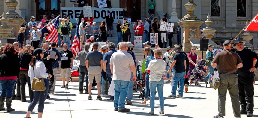 People gather at the Michigan State Capitol in protest of stay-at-home orders during the COVID-19 pandemic lockdown in 2020. 