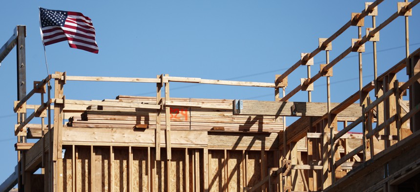 An American flag flies above the construction site of a multifamily housing development on June 2, 2023 in Los Angeles.