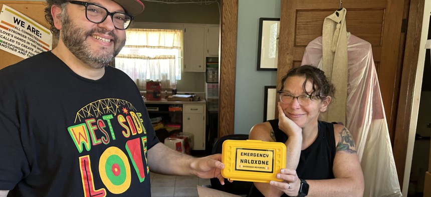 Joe Solomon, co-director of WV SOAR, and Sarah Stone, board president for the overdose prevention organization, pose with some of the naloxone wall boxes that will go out to participating counties during this year’s Save a Life Day. 