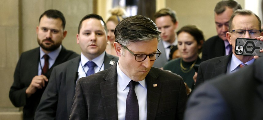 House Speaker Mike Johnson is followed by reporters as he walks to his office in the U.S. Capitol Building on Sept. 19, 2024. 