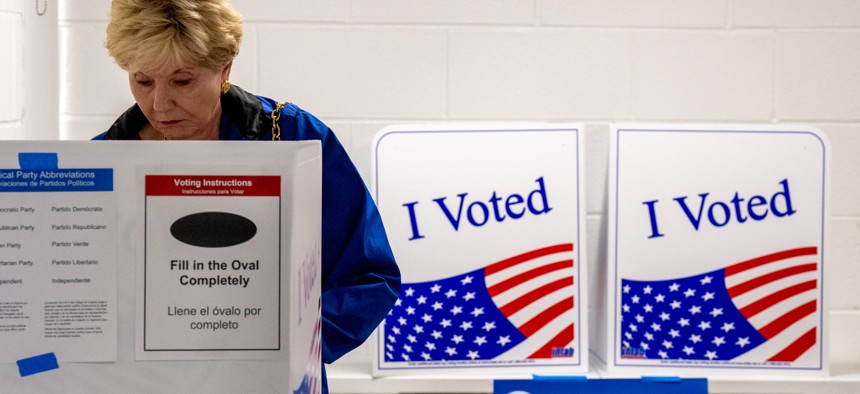 A woman votes on the first day of Virginia's in-person early voting at Long Bridge Park Aquatics and Fitness Center on Sept. 20, 2024 in Arlington, Va.