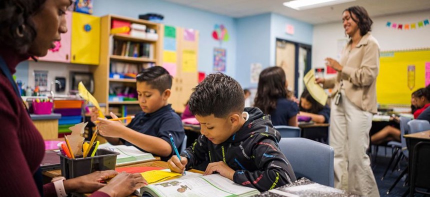 Aisha Thomas (L) learns teaching skills with teacher Alexxa Martinez, in her classroom in Nevitt Elementary School, in Phoenix, Arizona, on October 26, 2022.