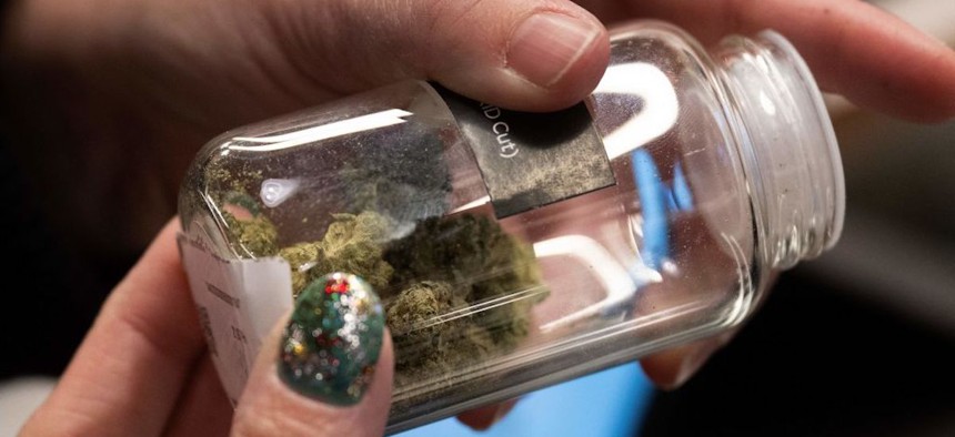 A customer looks at marijuana buds at the Proper Cannabis dispensary in Kansas City, Missouri, on March 17, 2023. 