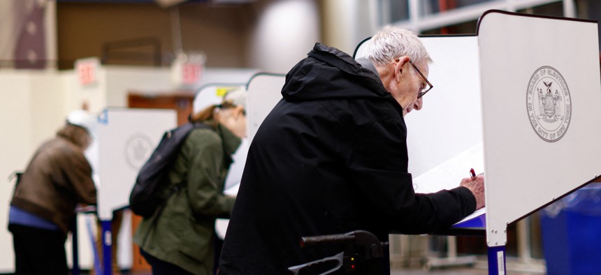 A voter fills out his ballot during first day of early voting in New York on October 26, 2024.