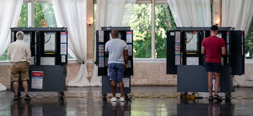 Voters cast ballots in Georgia's primary election at a polling location on May 21, 2024, in Atlanta, Georgia.