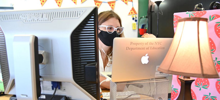 A teacher wears a mask and teaches remotely from her classroom on Sept. 24, 2020, in New York City. 