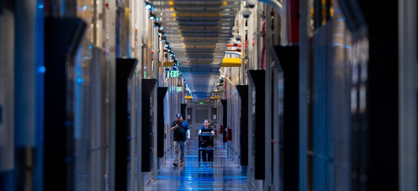 People walk through the hallways at Equinix Data Center in Ashburn, Virginia, on May 9, 2024.