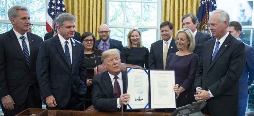 President Donald Trump at a 2018 signing ceremony establishing the Cybersecurity and Infrastructure Security Agency. Some worry that in his next term, the agency could be disbanded and complicate state cyber efforts.