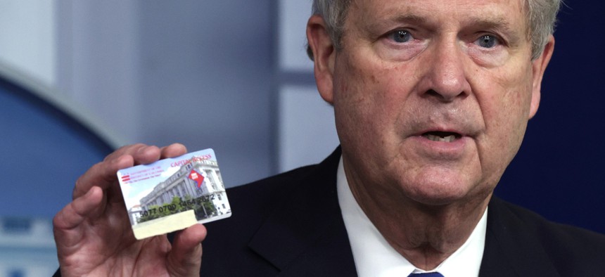 U.S. Secretary of Agriculture Tom Vilsack holds up a Supplemental Nutrition Assistance Program (SNAP) Electronic Benefits Transfer (EBT) card during a daily press briefing at the James Brady Press Briefing Room of the White House May 5, 2021. Federal reimbursement of stolen funds on such cards will end without congressional action.