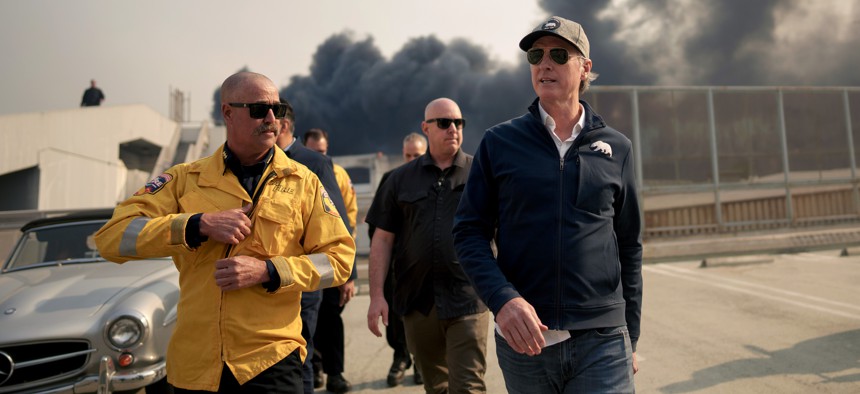 California Gov. Gavin Newsom, a Democrat, tours the downtown business district of Pacific Palisades as the Los Angeles fires still rage. Newsom launched a website to combat rampant misinformation about the fires.