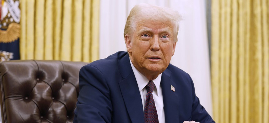 President Donald Trump speaks to reporters after signing a series of executive orders in the Oval Office of the White House on January 23, 2025 in Washington, DC. 