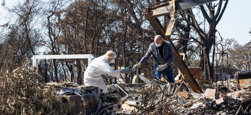 Karen and Steven Goddard look for what survived in the rubble of their Pacific Palisades house on Tuesday, Jan. 28, 2025. This was their first time back since evacuating Jan. 7.