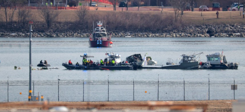 Emergency crews respond to the wreckage of an American Airlines jet and Army helicopter, which collided near an airport just outside Washington, D.C.