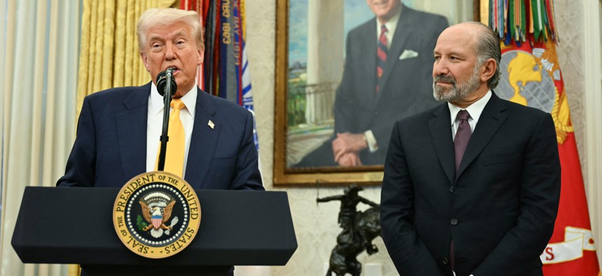 Commerce Secretary Howard Lutnick (right) listens as President Donald Trump speaks at his swearing-in ceremony. Lutnick on Wednesday announced a "rigorous review" of the $42 billion BEAD program.