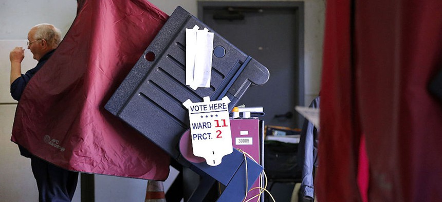 A voter walks out of a voting booth after casting his ballot on December 10, 2016, in New Orleans, Louisiana.