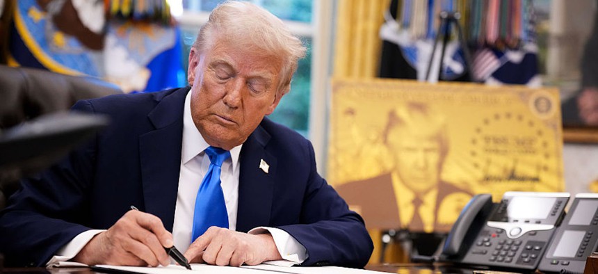 President Donald Trump signs an executive order in the Oval Office at the White House on Sept. 19, 2025, in Washington, DC. Trump signed a series of executive orders establishing the “Trump Gold Card” and introducing a $100,000 fee for H-1B visas. 