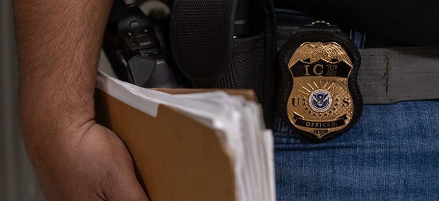 An Immigration and Customs Enforcement agent stands outside of immigration court hearings at Jacob K. Javits Federal Building on June 10, 2025, in New York City.