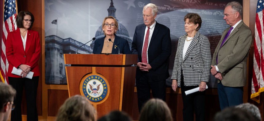 Sen. Maggie Hassan (center) speaks during a Senate press conference.