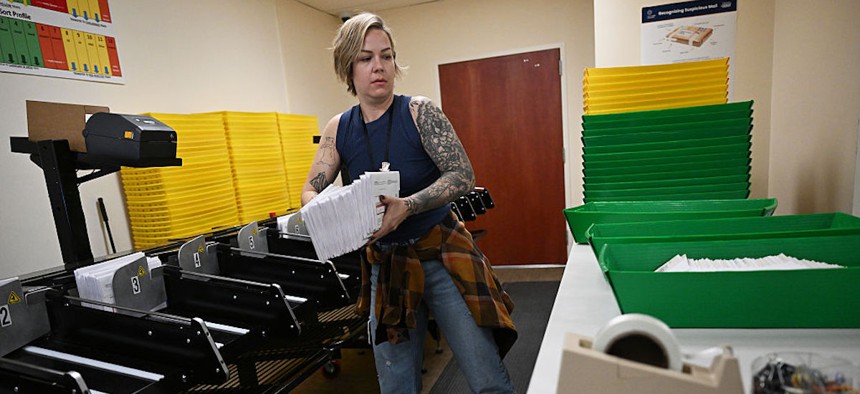 Election Judge Ashley Kidder works in the receiving room at the Denver Elections Division on Election Day in Denver on Nov. 4, 2025.