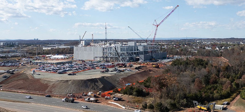 An aerial view shows cars passing a data center under construction in Ashburn, Virginia, on Nov. 12, 2025.