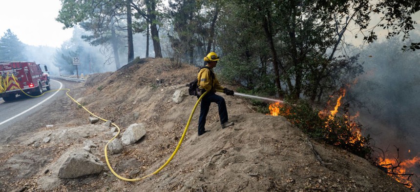 A firefighter battles the Line Fire in Angelus Oaks on Oct.1, 2024, in San Bernardino County, California. 
