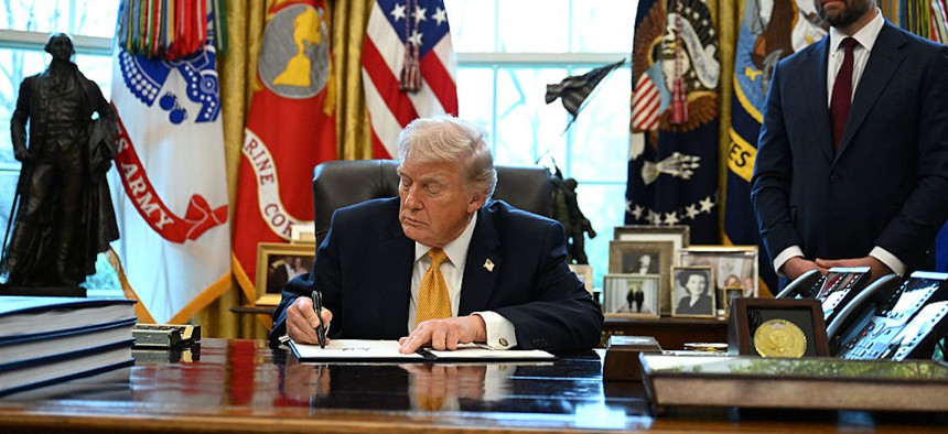 President Donald Trump signs an executive order on fraud in the Oval Office at the White House in Washington, DC, on March 16, 2026.