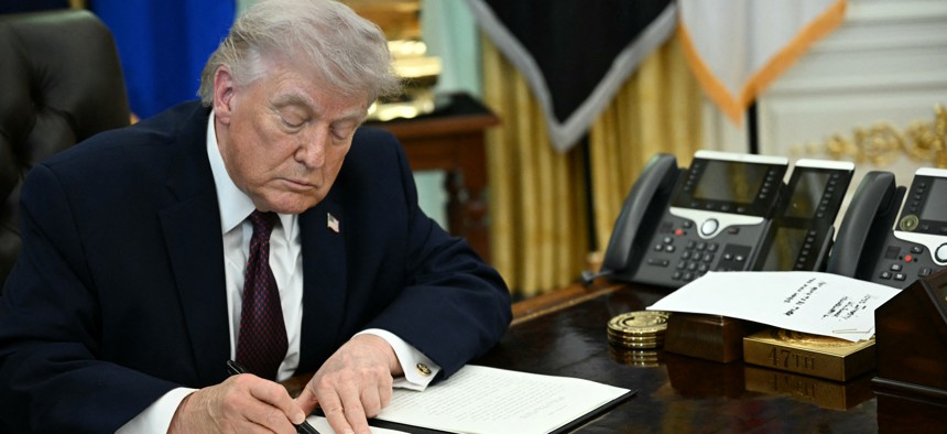 President Donald Trump signs an executive order cracking down on mail-in voting ahead of midterm elections in the Oval Office of the White House in Washington, DC, on March 31, 2026.