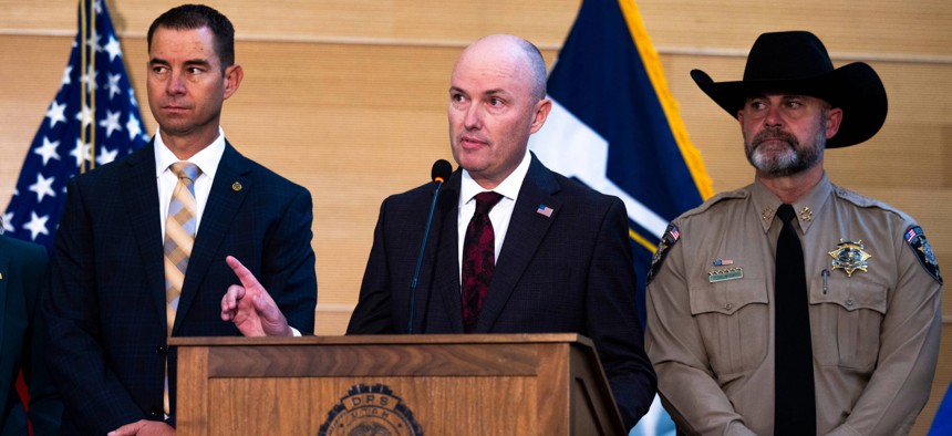 Utah Gov. Spencer Cox (center) speaks during a press conference last year.