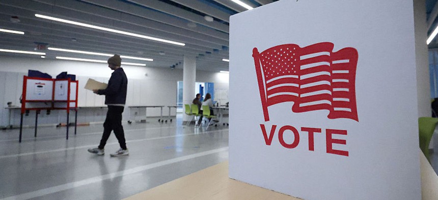 Voters cast their ballots at a polling location at Washington-Liberty High School on April 21, 2026, in Arlington, Virginia.