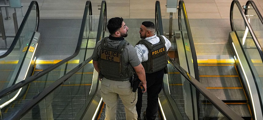 ICE agents ride an escalator at LaGuardia Airport on March 28, 2026, in New York