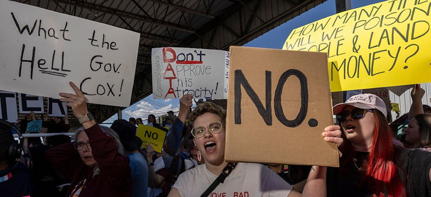 Alexa Chandler holds a sign protesting the construction of a data center on May 4, 2026, in Tremonton, Utah. The Box Elder County Commission is due to decide whether a 40,000 acre data center can be built near the north shore of the Great Salt Lake. 