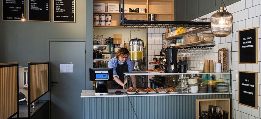 Barista Kajetan Grzelczak prepares pastries at the Andon Café in Stockholm on April 27, 2026. It looks like any other coffee shop, but this Stockholm cafe is entirely run by an AI chatbot - with a human barista following orders.