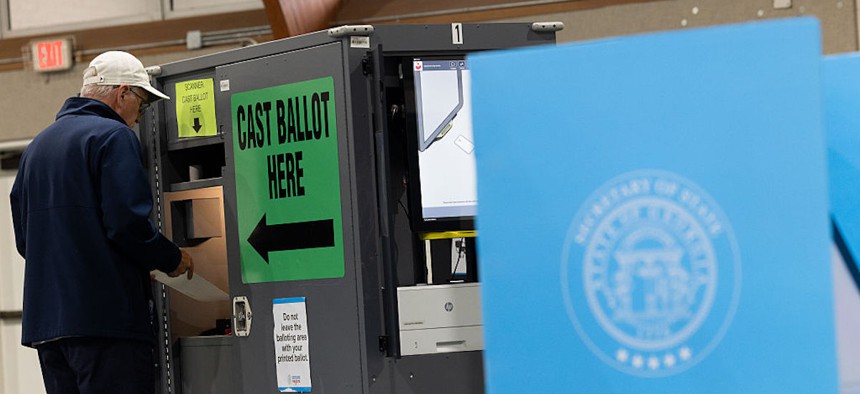 A voter scans his completed ballot at the Mt. Zion United Methodist Church polling station for the primary runoff election on June 16, 2026, in Marietta, Georgia.