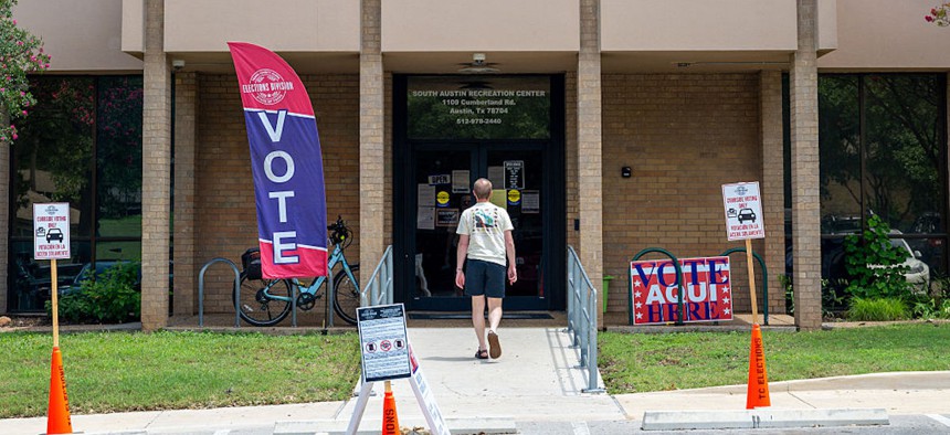 A person prepares to vote at the South Austin Recreation Center on May 26, 2026, in Austin, Texas